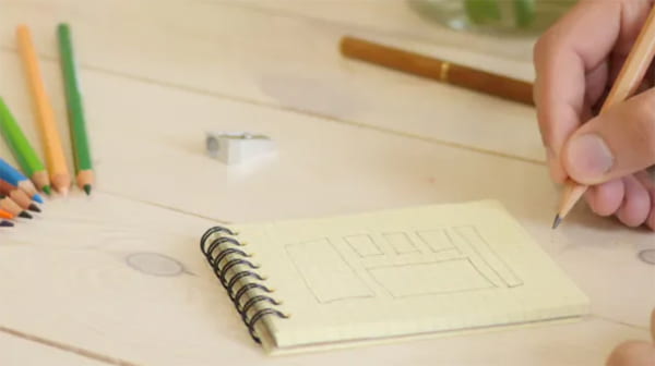 Planning a website using a pencil and a notepad